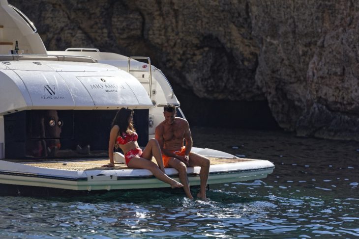 Couple sitting on back of yacht